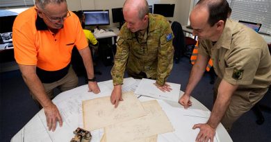 Colonel Bradley Robertson and Warrant Officer Class Two Steven Cosstick discuss options for making a replacement part for a surgical-mask manufacturing machine with David Mather at Med-Con Pty Ltd, a small manufacturer in Regional Victoria. Photo by Corporal Sagi Biderman.