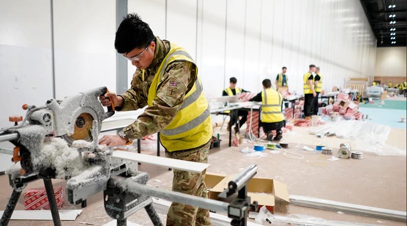 A British Army engineer works on fixings at the NHS Nightingale hospital in London's Docklands. UK MoD photo.