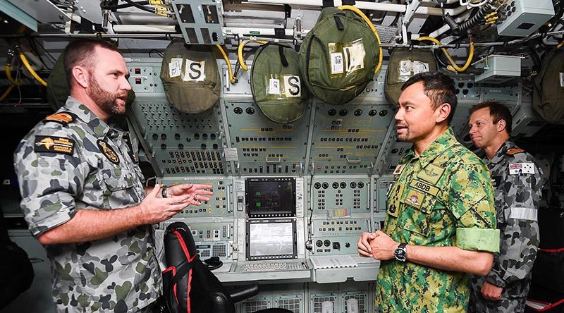 The Sultan of Brunei talks to HMAS Dechaineux's CO Commander Bradley Francis, with Chief of Navy Vice Admiral Mick Noonan in the background. Photo courtesy of Brunei's Information Department.