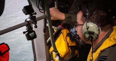 Deputy Director of Artificial Intelligence Wing Commander Michael Gan looks for a life raft off the Queensland coast during an assessment of the AI-Search system using GoPros for eyes. Photo by Corporal Jessica de Rouw.