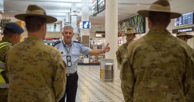 Inspector Peter Aitken from the Queensland Police Service briefs an Australian Army contingent from the 9th Battalion, Royal Queensland Regiment, supporting mandatory COVID-19 quarantine arrangements for international travellers at Brisbane Airport. Photo by Trooper Jonathan Goedhart.
