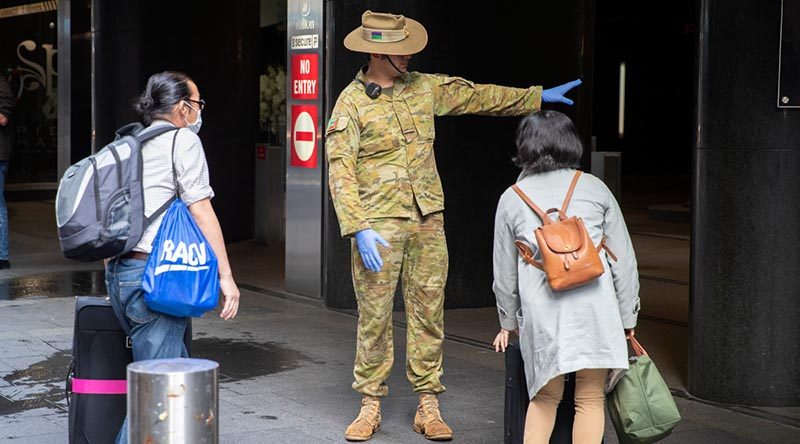 Australian Army soldier Private Claude Allan from 2nd/17th Battalion, Royal New South Wales Regiment, guides returning passengers to their hotel rooms in Sydney, as part of the government’s COVID-19 response. Photo by Corporal Chris Beerens.
