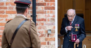 Colonel Tom Moore talks to Lieutenant Colonel Thomas Miller while holding The Yorkshire Regiment Medal, re-presented as a birthday gift from the British Army after he lost the original. Photo by Corporal Robert Weideman, UK Ministry of Defence.