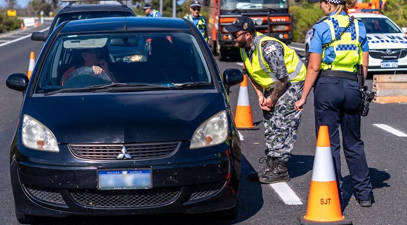 Leading Seaman Toby Pink from Naval Engineering Systems Centre in HMAS Stirling assists Western Australian Police Officer Constable Hanna Laundry from Rockingham Police Station to conduct a traffic stop on the Forest Highway in Lake Clifton as part of the ADF's support to the Western Australian governent during COVID-19. Photo by Leading Seaman Ronnie Baltoft.