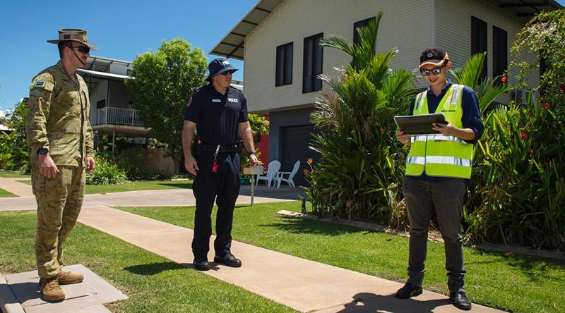 Australian Army soldier Lance Bombardier Jacob Homulos, Northern Territory Police Officer Senior Constable Maxwell Lisson and Department of Health Environmental Officer Jerry Chen conduct quarantine compliance checks in Darwin. Photo by Captain Carla Armenti.