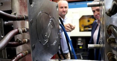 Axiom Managing Director Jim Grose and Ben Barona from Defence Science and Technology Group examine an injection moulding die used to manufacture face-mask components. ADF photo.