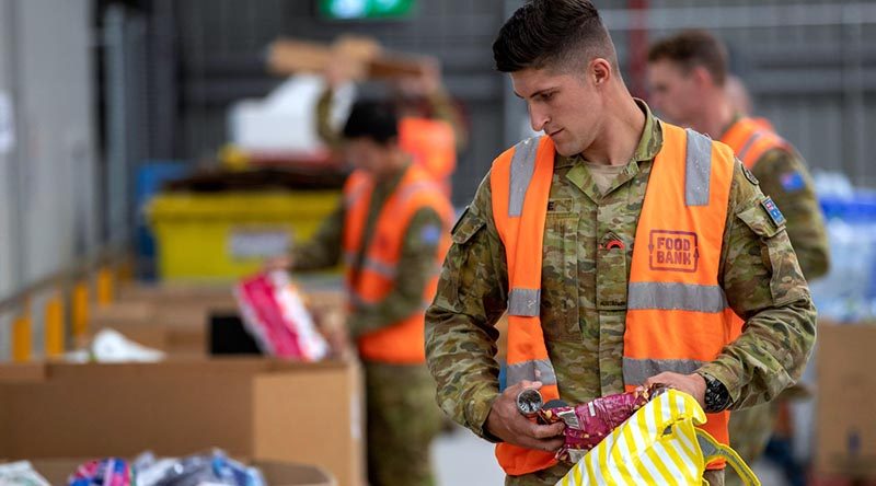 Australian Army soldier Private Jack Barrie sorts donations at the Foodbank warehouse in Glendenning, NSW, as part of Defence's Operation COVID-19 Assist. Photo by Corporal Chris Beerens.