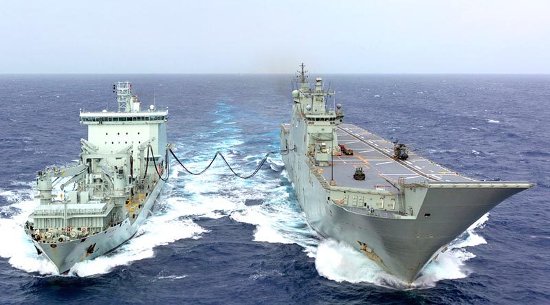 HMAS Adelaide conducts a replenishment-at-sea fuel transfer with Royal Canadian Navy supply ship MV Asterix during the sea phase of Exercise RIMPAC 18. Photo by Able Seaman Ronnie Baltoft.