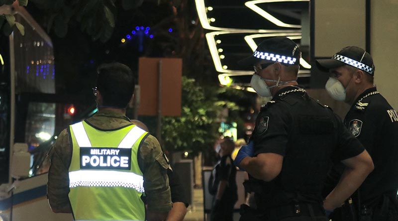 Australian Army military police and Queensland police stand guard outside The Westin, Brisbane, as more  more Aussies coming off overseas flights arrive for quarantine. Photo by CONTACT stringer Christabel Migliorini.