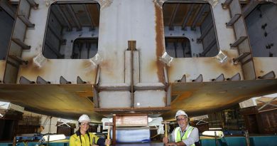 Evyenia Kontakos, a fourth-year apprentice welder and boilermaker with the Australian Submarine Corporation and Larry Lavallee, OPV Block Construction Manager, pose for an official photo after hammering in wedges to secure the Chief of Navy's ceremonial coin in place during NISHIP Eyre's keel laying ceremony. Photo by Russell Millard.