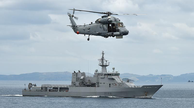 HMNZS Otago, pictured with a Seasprite helicopter hovering overhead, is one of four Royal New Zealand Navy ships that will be visible in the Hauraki Gulf over the next few weeks as they carry out training essential to maritime operations. RNZN photo.