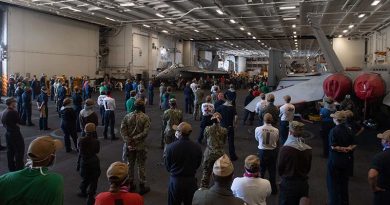 Crew of the USS Theodore Roosevelt listen to Vice Admiral William Merz, commander US 7th Fleet, answering questions during a visit to the ship on 7 April 2020. US Navy photo by Mass Communication Specialist Seaman Kaylianna Genier.