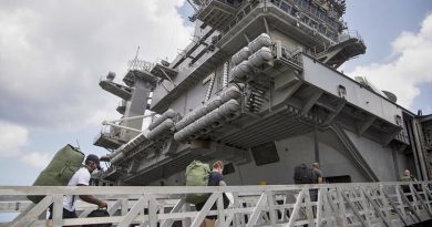 USS Theodore Roosevelt 'clean-crew' sailors re-board the aircraft carrier after completing their COVID-19 isolation period in Guam. Photo by US Marine Corps Staff Sergeant Jordan E Gilbert.