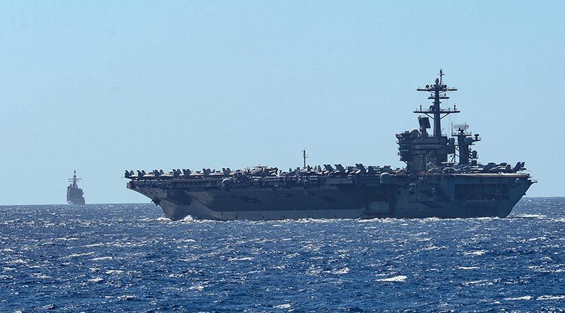 The aircraft carrier USS Theodore Roosevelt and the Ticonderoga-class guided-missile cruiser USS Bunker Hill transit the Philippine Sea in February. US Navy photo by Mass Communication Specialist 3rd Class Sean Lynch.