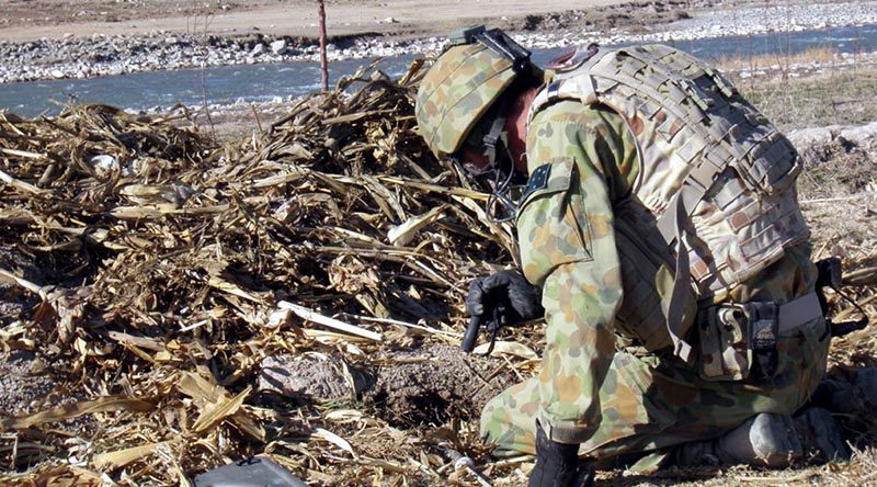 Flight Sergeant Damian Holding conducting a search for unexploded ordnance in Afghanistan.