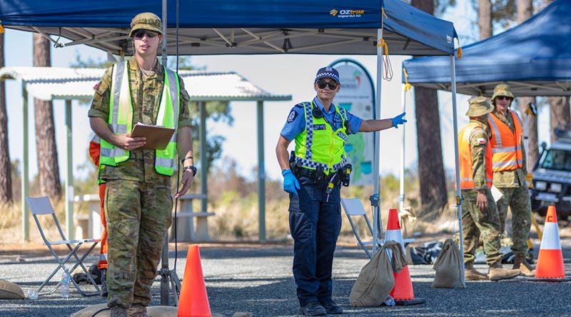 Private Connor Place-Diamond from 16th Battalion, Royal Western Australia Regiment, assists Western Australian Police Officer First Class Constable Linda Taurima to conduct a traffic stop on Indian Ocean Drive in Wilbinga as part of the Defence Assistance to the Civil Community support for COVID-19 Assist. Photo by Leading Seaman Ernesto Sanchez.