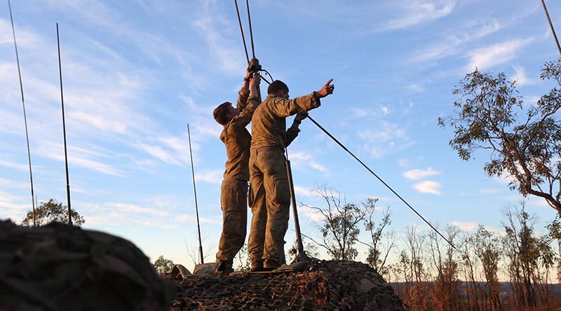 Soldier from 1RAR set up comms at High Range Training Area. Photo by Brian Hartigan.