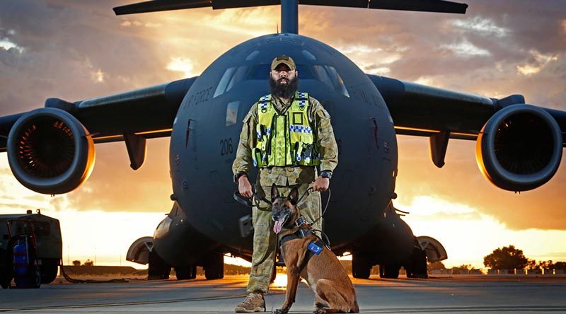 Military working-dog handler Corporal Brodie McIntyre with his dog Kesha provides security to an Air Force C-17A Globemaster at RAAF Base Darwin. Photo by Sergeant Ben Dempster.