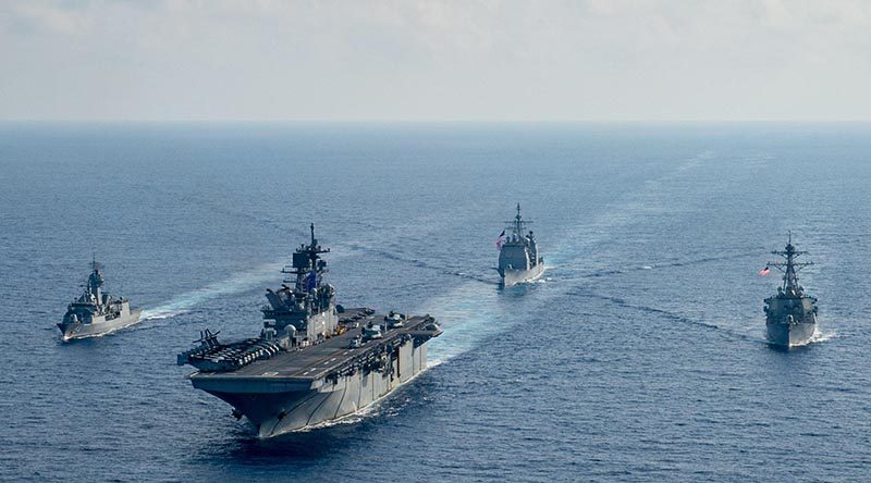 Royal Australian Navy frigate HMAS Parramatta (left) conducts officer-of-the-watch manoeuvres with amphibious assault ship USS America, guided-missile cruiser USS Bunker Hill and guided-missile destroyer USS Barry in the South China Sea. Photo by USS America crew member.