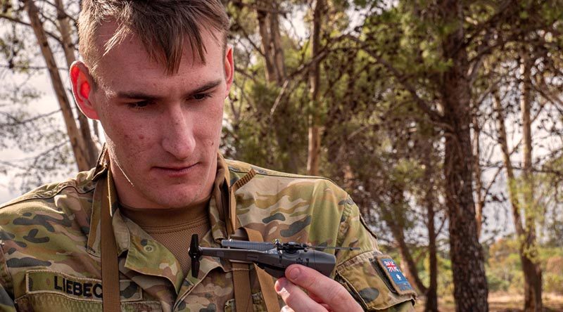 Lance Corporal Ash-Leigh Liebeck, 7RAR, inspects a Black Hornet nano UAV. Photo by Private Luke Jones.