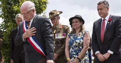 Mayor of Villers-Bretonneux Dr Patrick Simon (left) at a headstone rededication for an Australian soldier of WWI at Villers-Bretonneux Cemetery. Photo by Sergeant Janine Fabre.