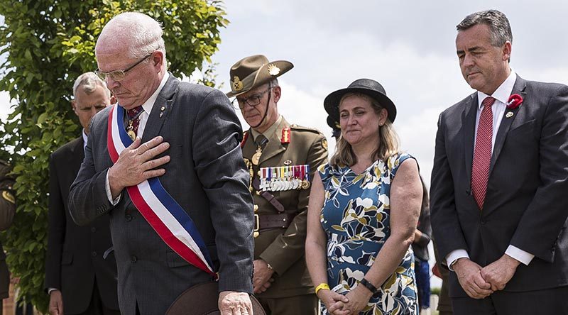 Mayor of Villers-Bretonneux Dr Patrick Simon (left) at a headstone rededication for an Australian soldier of WWI at Villers-Bretonneux Cemetery. Photo by Sergeant Janine Fabre.