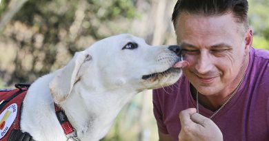 Former Australian infantryman Andrew Glebow gets a 'kiss' from his new assistance dog Leon in his back yard at Shailer Park, Brisbane.