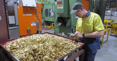 Patrick Warner of Thales Australia examines cartridge cases for 5.56mm ammunition during the manufacturing process at Benalla, Victoria.