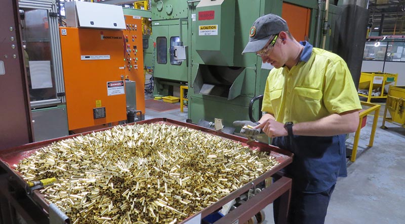Patrick Warner of Thales Australia examines cartridge cases for 5.56mm ammunition during the manufacturing process at Benalla, Victoria.