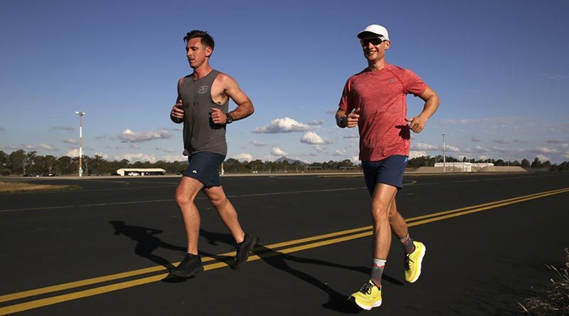 Pilots Flight Lieutenant Tom, right, and support crew member Flight Lieutenant Sam, from No. 1 Squadron, maintain the pace during the 24-hour charity running challenge at RAAF Base Amberley. Photo by Corporal Colin Dadd.