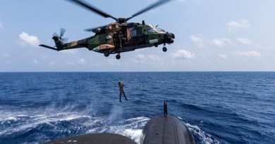 A Royal Australian Navy sailor is lowered to the casing of HMAS Collins from an MRH-90 helicopter in the Bay of Bengal during AUSINDEX 2019. Photo by Leading Seaman Jake Badior.