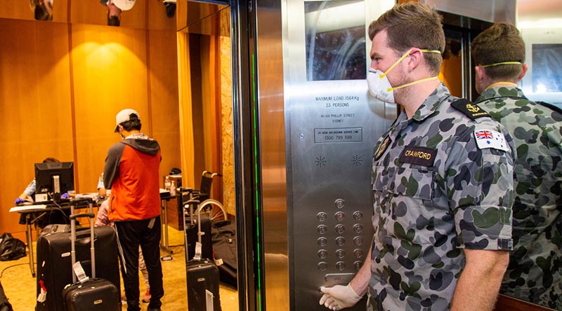 Leading Seaman Michael Crawford waits in a lift of a Sydney hotel to assist travellers going into mandatory 14-day quarantine. Around 850 of 1000 ADF member being deployed to Victoria will be assigned to similar duties in Melbourne. Photo by Petty Officer Justin Brown.