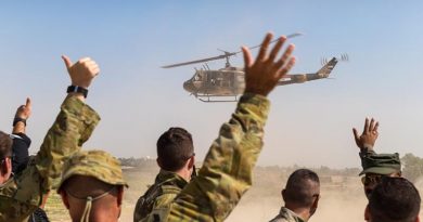 Australian soldiers and Iraqi forward air controllers wave to the crew of an Iraqi Army helicopter as it departs at the conclusion of training at Taji Military Complex, Iraq. Photo by Corporal David Said.