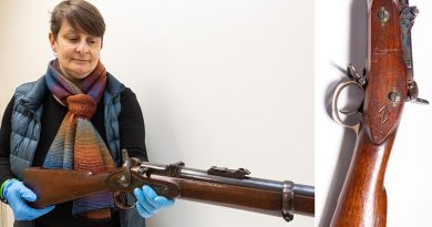 Corinne Ball, Curator History Trust of South Australia, inspects the 1868 Braendlin-Albini rifle. Photo by Leading Aircraftwoman Jacqueline Forrester.