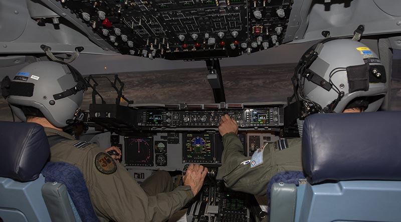 No. 36 Squadron pilots Flight Lieutenants Tim Smith, left, and Matthew Bruton fly a mission in the C-17A Globemaster III simulator during Exercise Virtual Pitch Black at RAAF Base Amberley. Photo by Sergeant Peter Borys.