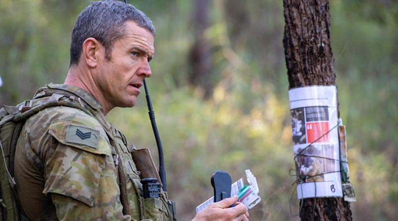 Sergeant Peter Byrnes, from the 8th/9th Battalion, Royal Australian Regiment, checks his notes during Exercise Ramsilience at Gallipoli Barracks, Brisbane. Photo by Trooper Jonathan Goedhart.