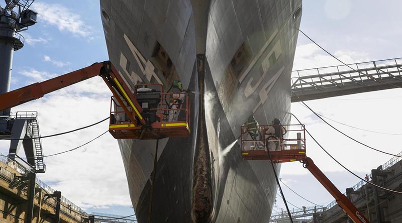 Defence contractors conduct maintenance on HMAS Parramatta during her refit in the Captain Cook Graving Dock at Garden Island, Sydney. Photo by Leading Seaman Leo Baumgartner.