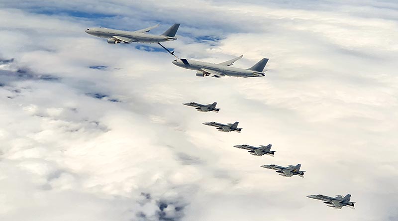 F/A-18A Hornets fly in formation with KC-30A multirole tanker transports enroute to Guam. RAAF photo.