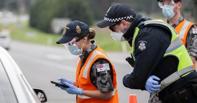Royal Australian Navy Seaman Kirie South, from HMAS Cerberus, checks a driver’s details at a vehicle control point in Victoria, assisting the Victoria Police Force during Op COVID-19 Assist. Photo by Leading Aircraftman John Solomon.
