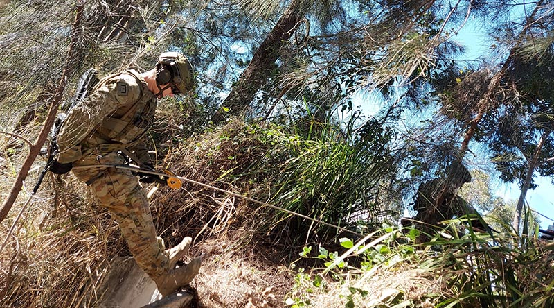 A soldier from 2CER abseils to a casualty in a confined space during personnel rescue training in Brisbane.