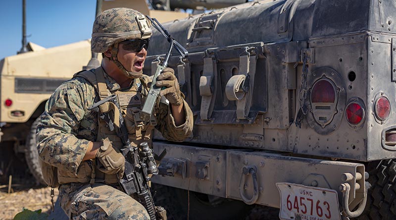 US Marine Corps Sergeant Jacob Montana with Combined Anti-Armor Team, Ground Combat Element, Marine Rotational Force – Darwin, relays commands to his Marines during a simulated fire mission at Mount Bundey Training Area, NT. US Marine Corps photo by Corporal Lydia Gordon.