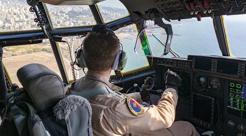 A Royal Australian Air Force pilot look over Beirut from the flight deck of his C-130J Hercules loaded with Australian aid relief supplies for the people of Lebanon. Photo by Corporal Tristan Kennedy.