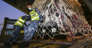 Royal Australian Air Force Air Movements Operator Corporal Adam Fraser from No. 23 Squadron, loads personal protective equipment destined for Indonesia on to a No. 37 Squadron C-130J Hercules at RAAF Base Amberley. Photo by Corporal Colin Dadd.