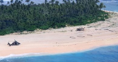 An Australian Army ARH Tiger helicopter lands on Pikelot Island in Micronesia. The SOS message of the stricken sailors can be seen on the beach. ADF photo.