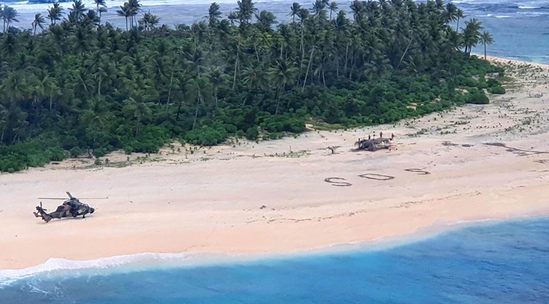 An Australian Army ARH Tiger helicopter lands on Pikelot Island in Micronesia. The SOS message of the stricken sailors can be seen on the beach. ADF photo.