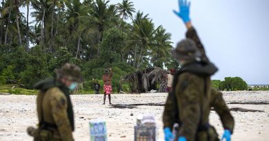 Australian soldiers from 2RAR, keeping their distance because of COVID-19, deliver supplies to three Micronesian mariners stranded on a small island awaiting rescue. Photo by Leading Seaman Kieren Whiteley.