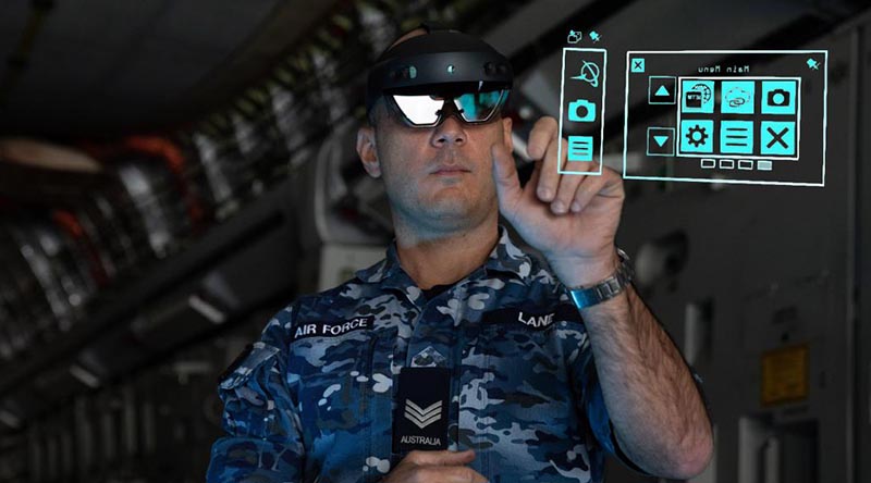 Sergeant Thomas Lane from No. 36 Squadron uses the HoloLens mixed-reality device during maintenance of a C-17A Globemaster III aircraft.