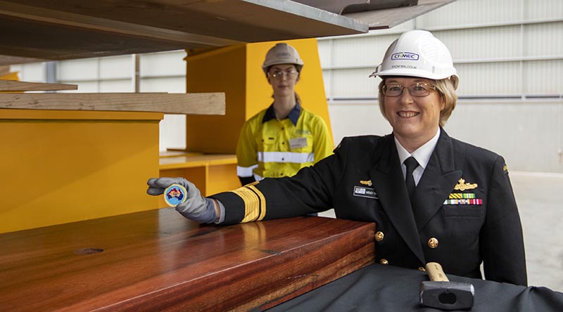 Head of Maritime Systems Rear Admiral Wendy Malcolm displays the Chief of Navy’s ceremonial coin about to be placed under the keel NUSHIP Pilbara at the Civmec facility in Henderson, Western Australia. Photo by Leading Seaman Ronnie Baltoft.