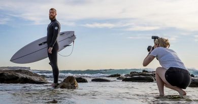 Royal Australian Air Force imagery-specialist trainee Aircraftwoman Emma Schwenke captures a portrait of Royal Australian Navy Leading Seaman Michael Douglas from HMAS Canberra, at Maroubra Beach. Photo by Sergeant Christopher Dickson.