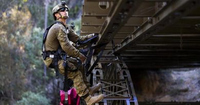 Lieutenant James Bonney attaches simulated explosives to a bridge during the final field phase of the Engineer Regimental Officer Basic Course. Photo by Sergeant Ray Vance.